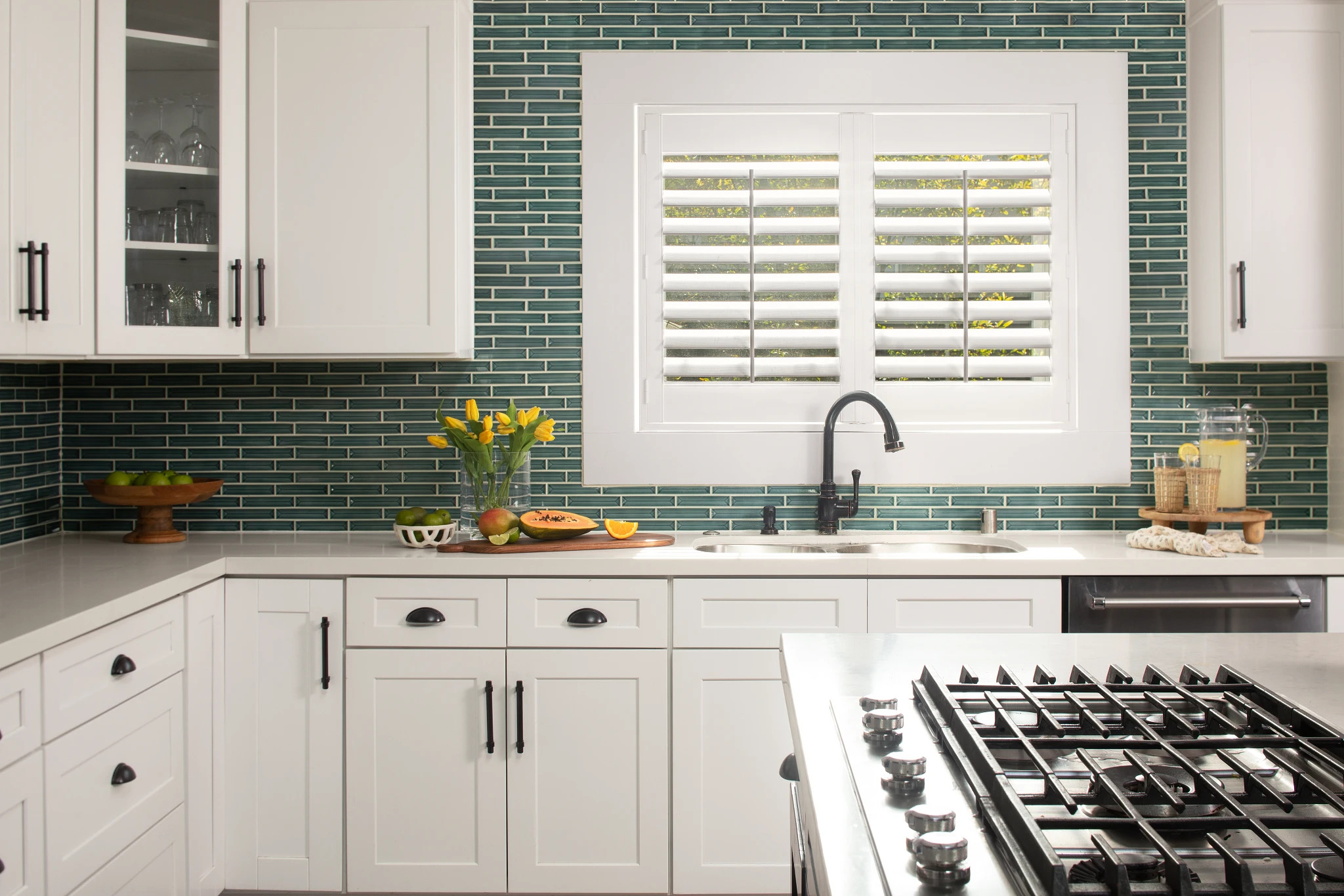 Coastal-style white window shutters in a bright room