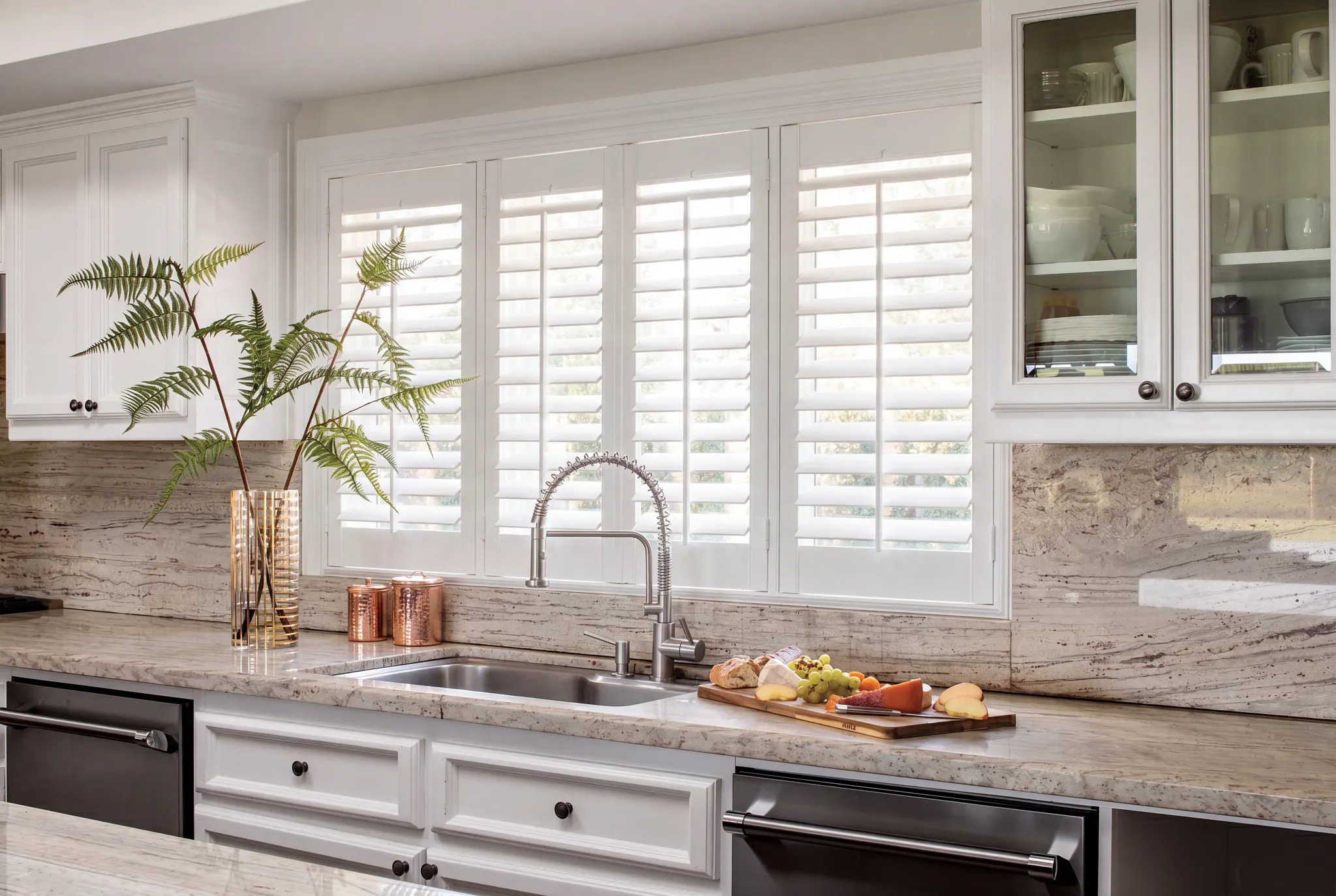 Coastal-style white window shutters in a bright room